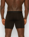 Person wearing spicy wear black boxer briefs on a plain background