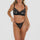 A woman wearing a black stretch lace balconette bra with exquisite lace detailing.